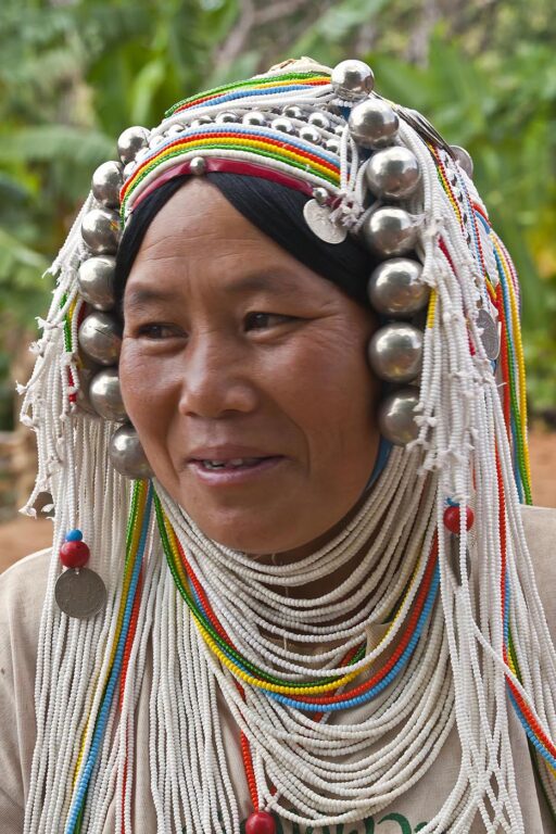 Women of the AKHA tribe wear elaborate headdresses made of beads, silver coins and hand loomed cotton - village near KENGTUNG or KYAINGTONG,  MYANMAR
