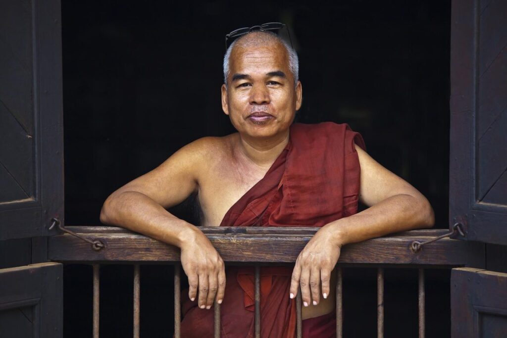 A MONK at the teak BAGAYA KYAUNG MONASTERY which dates back to 1834 in historic INWA which served as the Burmese Kingdoms capitol for 400 years - MYANMAR