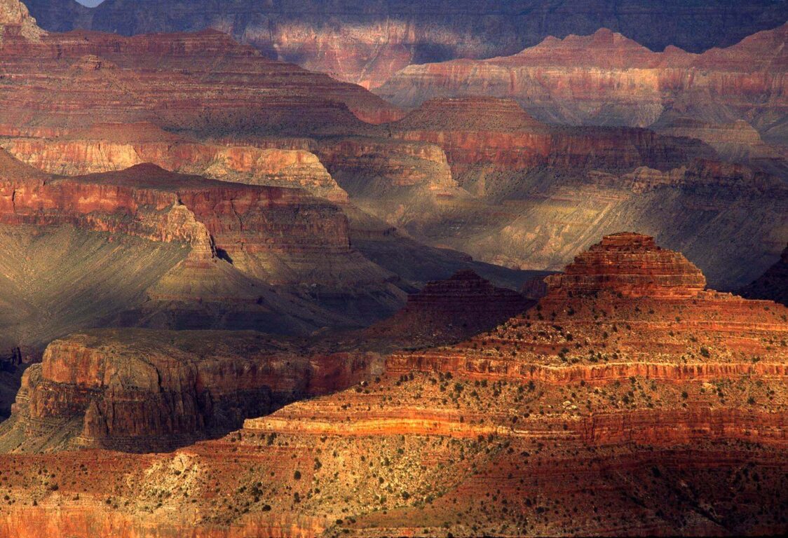 Late afternoon sunlight dances among the rock formations of the GRAND CANYON as seen from the South Rim - ARIZONA