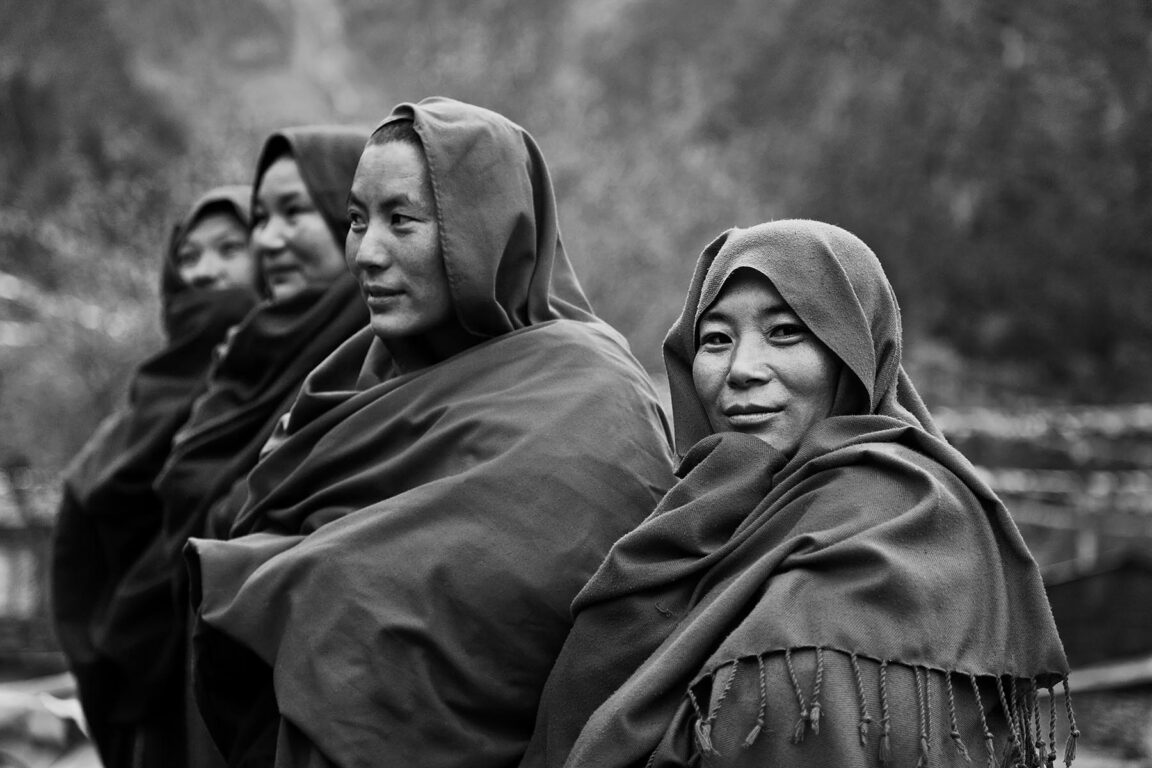 Ningmapa nuns wear traditional robes at a remote TIBETAN BUDDHIST MONASTERY - NEPAL HIMALAYA