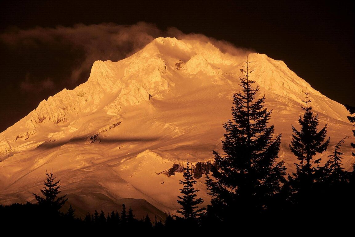 Late afternoon sunlight hits snow covered MOUNT HOOD outside of PORTLAND OREGON